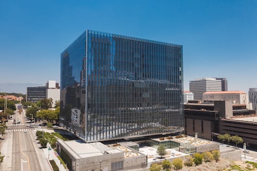 Aerial view of a modern glass office building in downtown Los Angeles.